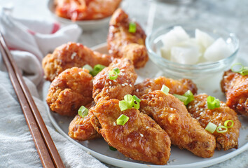 korean fried chicken wings with pickled radish and kimchi