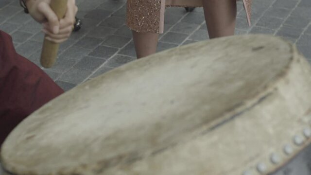 He is playing the drum