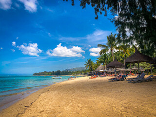 Families enjoying a beach vacation on a sunny day.