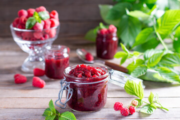 Homemade jam with raspberry on the wooden table