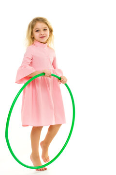 Beautiful Barefoot Girl in Pink Dress Standing with Hula Hoop