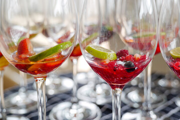 Selected focus at preparation of  Triple Berry Margaritas or Berry Vodka Cocktails with strawberries, blueberry, blackberry and lime serve on glass with salt on top. 
