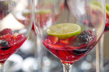 Selected focus at preparation of  Triple Berry Margaritas or Berry Vodka Cocktails with strawberries, blueberry, blackberry and lime serve on glass with salt on top. 