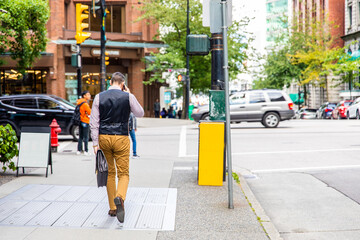 people walking in the city. Business man is on the phone 