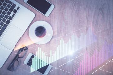 Multi exposure of financial chart hologram over desktop with phone. Top view. Mobile trade platform...