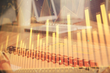 Double exposure of financial graph drawings and desk with open notebook background. Concept of forex market