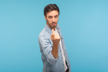 Come to me! Portrait of handsome young man in stylish denim shirt making beckoning gesture,...