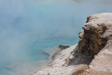Framed rocky edge of steaming hot springs in Yellowstone National Park.