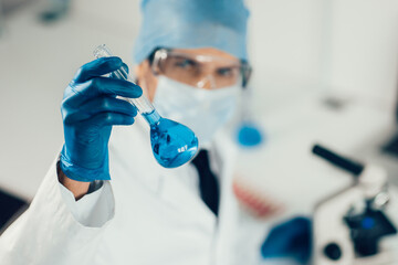 close up. medical flask in the hands of the researcher.