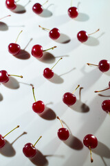 Naklejka na ściany i meble Group of cherry on a white background with shadows. Close-up. Top view.