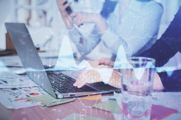 Multi exposure of woman hands typing on computer and forex chart hologram drawing. Stock market analysis concept.
