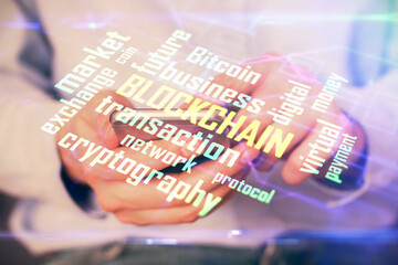 Double exposure of man's hands holding and using a phone and crypto currency blockchain theme drawing.