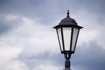 Fototapeta na wymiar Street lamp against a cloudy sky