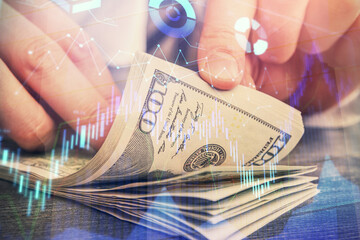 Multi exposure of forex graph drawing hologram and USA dollars bills and man hands. Technical Analysis concept.