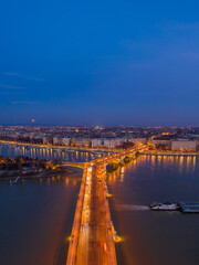 Fototapeta na wymiar Aerial drone shot of Margaret Bridge with lights on over Danube river during Budapest sunset