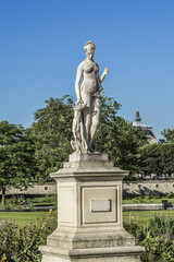 Ancient sculpture in Jardin des Tuileries (Tuileries garden) - favorite spot for rest of tourists and Parisians. Garden created by Catherine de Medici in 1564. Paris, France.