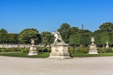Fototapeta na wymiar Ancient sculpture in Jardin des Tuileries (Tuileries garden) - favorite spot for rest of tourists and Parisians. Garden created by Catherine de Medici in 1564. Paris, France.