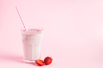 Fresh milkshake with strawberries on pink background. Summer detox drink. Place for text.
