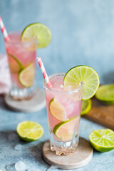 Fototapeta premium Fresh pink cocktail or mocktail with lime and pink juice and crushed ice, grapefruit paloma, pink lemonade