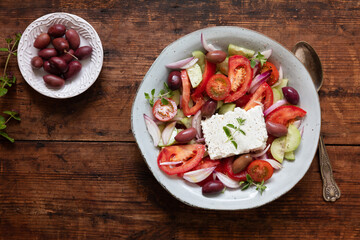A fresh traditional greek salad horiatiki choriatiki with feta cheese, tomatoes, cucumber, onion and kalamata olives