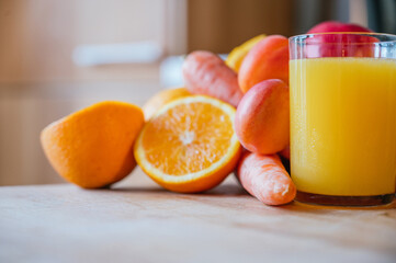 Healthy orange juice with sliced oranges on a wooden table