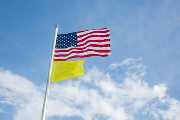 American Flag and Yellow Flag Flying at the Beach - Medium Hazard