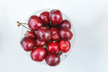 Fresh ripe cherries in a plastic Cup.