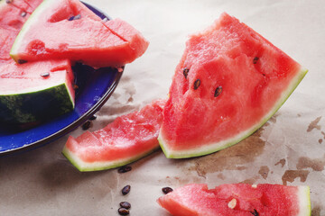 Juicy red watermelon slices lie on the table. Summer food, still life.