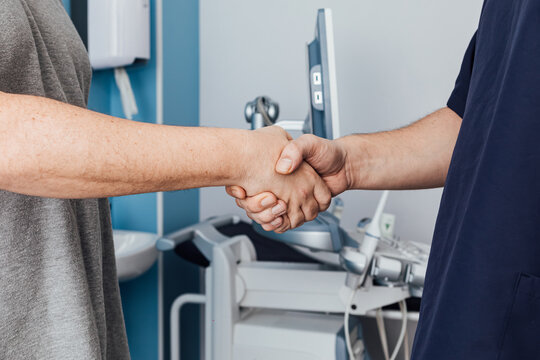 Doctor and patient greeting each other shaking hands