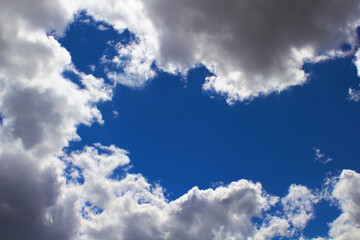 Blue sky with clouds and sun.