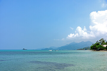 Two boats on clear water beach with background mountain and beautyful cloud at Koh Chang Thailand