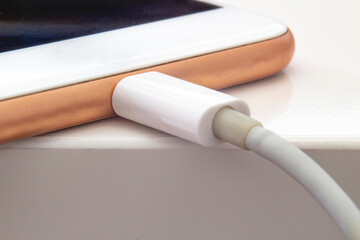 Close up of a smart phone changing on a white table