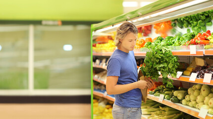 Young man buying vegetables at the market