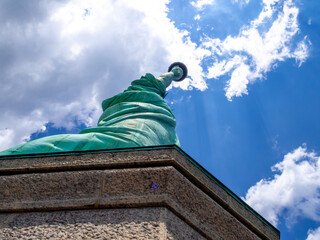close bottom up view of Statue of Liberty in America on a hot summer day © Michele