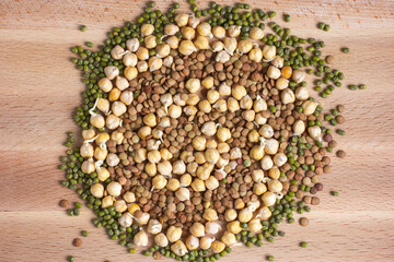 Sprouted chickpeas, lentil and mung on wooden background. Top view.
