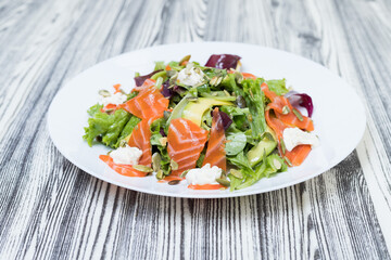 salad with vegetables and red fish