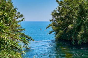Landscape from the top of a waterfall. Lower Duden waterfall in Antalya. Landscape photo on the sea and a bird flying against the sky