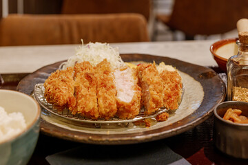Selected focus at Tonkutsu menu, Japanese deep fried port serve with rice and miso soup, on table in Japanese restaurant. 