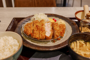 Selected focus at Tonkutsu menu, Japanese deep fried port serve with rice and miso soup, on table in Japanese restaurant. 