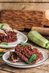 Vegan crunchy chocolate zucchini cake on rustic wooden. Healthy gluten free food.