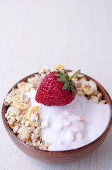 Clay Cup with muesli, yogurt and strawberries, place for text