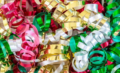 Fototapeta na wymiar background texture- close up of shiny colorful Christmas curling ribbon