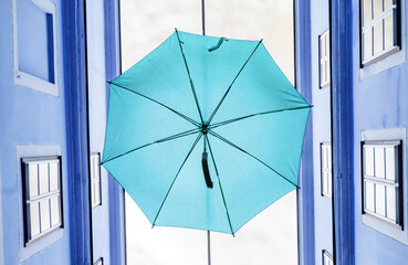 Blue umbrella hanging out above old passage street in Vienna