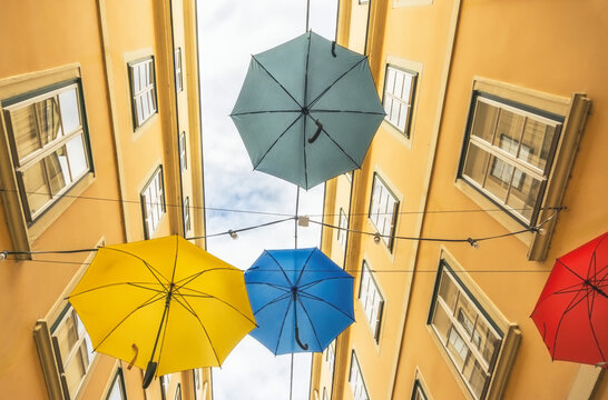 Colorful umbrellas hanging out above old passage street in Vienna