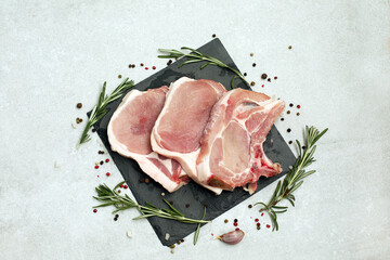 Raw pork steak on bone on light background.