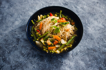 plant-based food, vegan singaporean laksa soup with vermicelli noodles and stir fry veggies