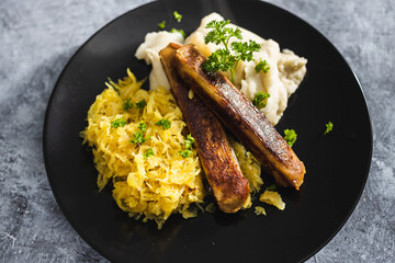 plant-based food, vegan sausages with sauerkraut and mash potatoes
