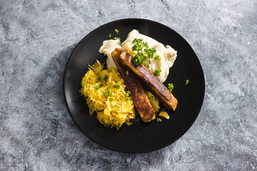 plant-based food, vegan sausages with sauerkraut and mash potatoes