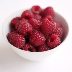 Close up of some raspberries in a bowl