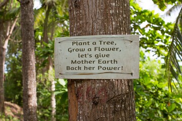 environmental conservation sign on a tree in the forest 